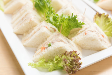 Freshly made of mixed sandwich triangles on wooden background.