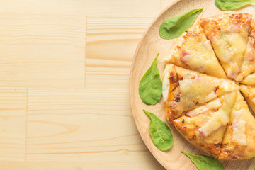Rustic pizza on wooden background. Top view