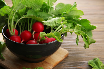 Fresh red radish on wooden table, closeup