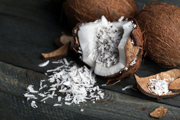 Coconut shavings in coconut on wooden background