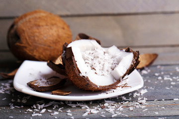 Coconut shavings in coconut on wooden background