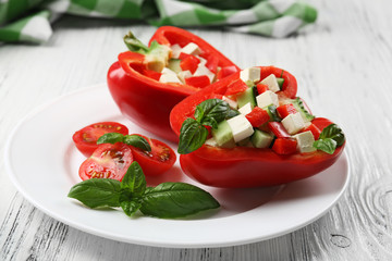 Fresh green salad in pepper on table close up
