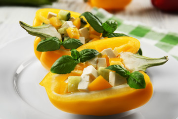 Fresh green salad in pepper on table close up