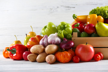 Fototapeta na wymiar Heap of fresh fruits and vegetables on wooden background