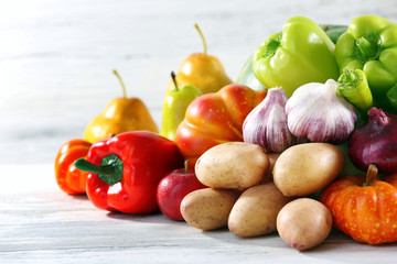 Heap of fresh fruits and vegetables on wooden background