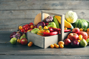 Heap of fresh fruits and vegetables on wooden background