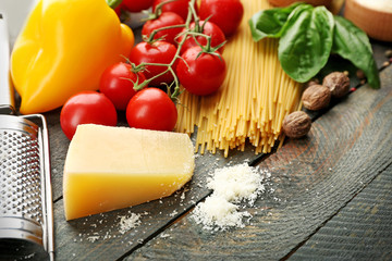 Pasta spaghetti with tomatoes, cheese and basil on rustic wooden  background