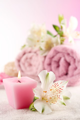 Obraz na płótnie Canvas Spa treatment and flowers on wooden table, on light background