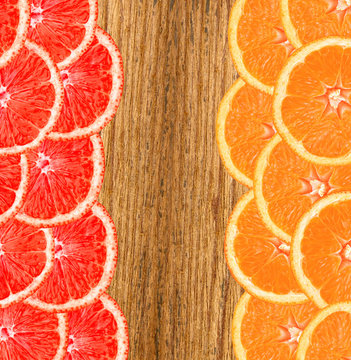 Fresh slice of grapefruit and orange on wooden background