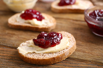 Fresh toast with butter and jam on table close up