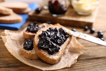 Fresh toast with butter and jam on table close up