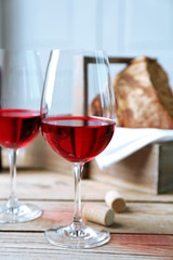 Still life of wine and bread on light background