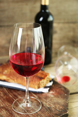 Still life of wine and bread on rustic wooden background
