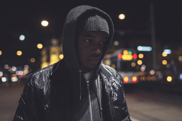 Urban fashion afro man with woolen cap and hoody on the streets