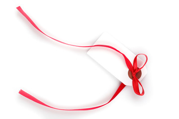 Blank gift tag with bow isolated on white