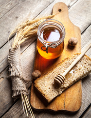 Honey in a jar, slice of bread, wheat
