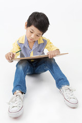 Happy Asian boy holding a blank art board