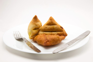 baked and fried keema samosa filled with boiled potato and mutton keema stuffiing - a traditional indian food for breakfast