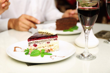 piece of chocolate cake and wine glass