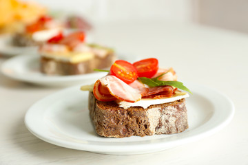 Tasty sandwiches on plates, close up