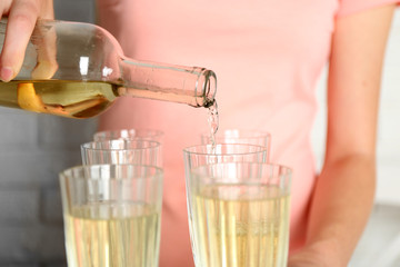 Woman pouring wine into glass, close up