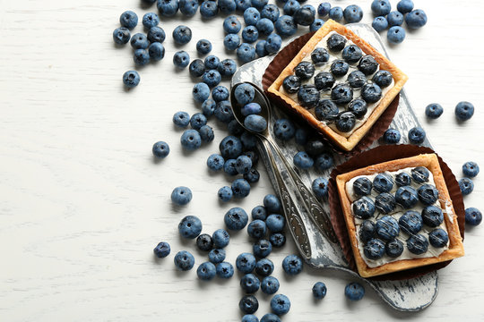 Gourmet fresh blueberry tarts on table