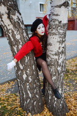 the girl is MIME hugging a lamppost