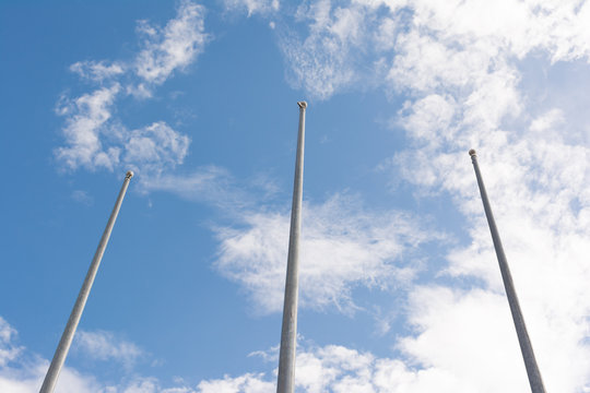 Three Empty Flag pole in outdoor stadium