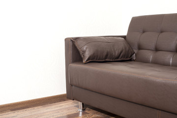 Brown leather sofa in room