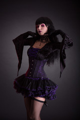 Beautiful gothic girl in purple and black costume