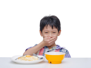 Asian child close his mouth by hand between having lunch