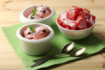 Watermelon ice cream in bowls  on color wooden background
