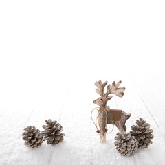 Natürliche Weihnachtsdekoration in weiß und braun mit freigestelltem Hirsch.