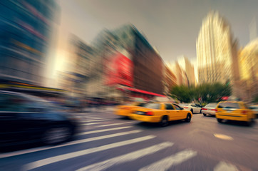 Blurry abstract photo in a city with people and vehicles in New York City, USA