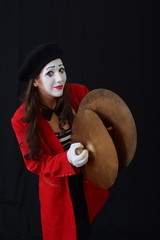 brunette MIM stands with timpani parts in his hands