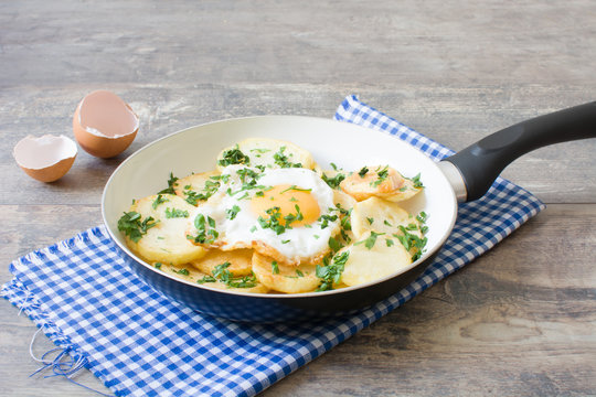 Potatoes and fried egg with parsley