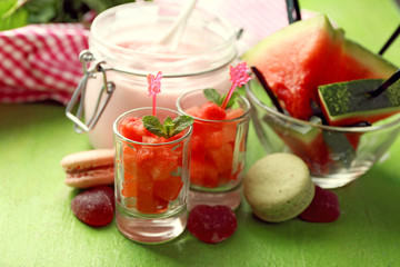 Watermelon ice cream in glass jars  on color wooden background