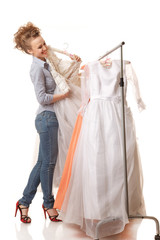 Young beautiful woman is choosing wedding dress