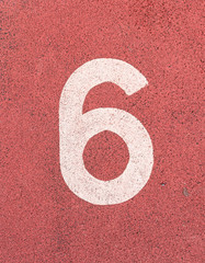 Number six,White track number on rubber racetrack, texture of ru