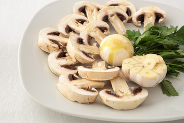 Can of raw mushrooms with garlic and parsley.