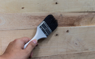 man hand brush and painting on the wooden