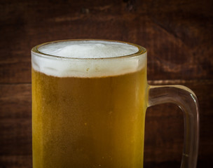 closeup beer in glass on wooden background