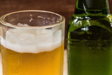 closeup beer in glass on wooden background