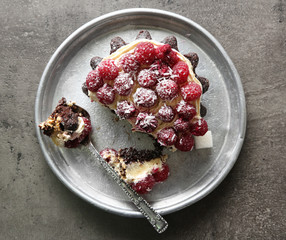 Sweet cake with raspberries on dark background