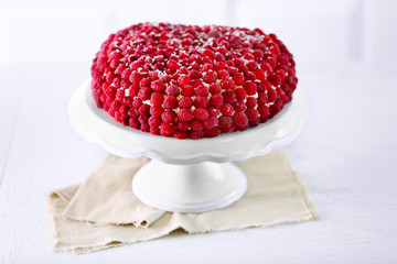 Sweet cake with raspberries on light background