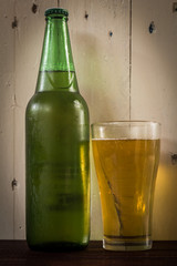 beer in glass on wooden background
