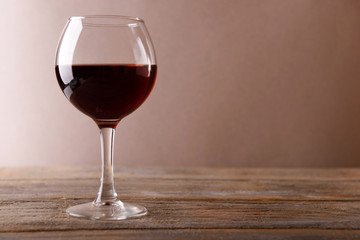 Glass of red wine on wooden table
