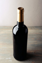 Fototapeta premium Bottle of red wine on wooden table