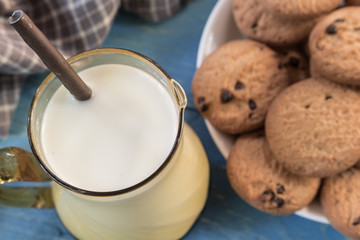 Close up cookies and glass of milk on wooden table