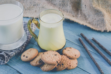 Close up cookies and glass of milk on wooden table - Vintage Sty